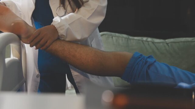 Physical therapist performing ankle examination on patient in clinic