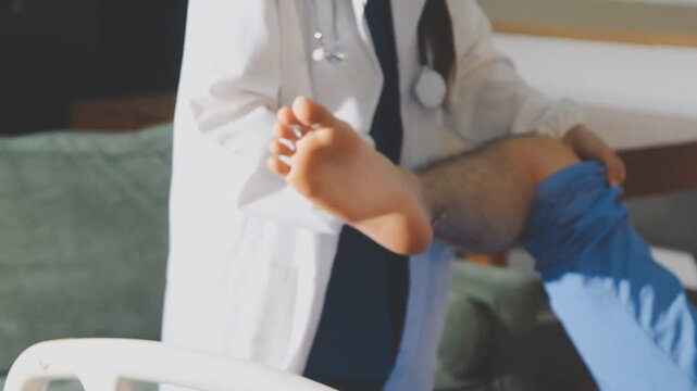 Physical therapist performing ankle examination on patient in clinic