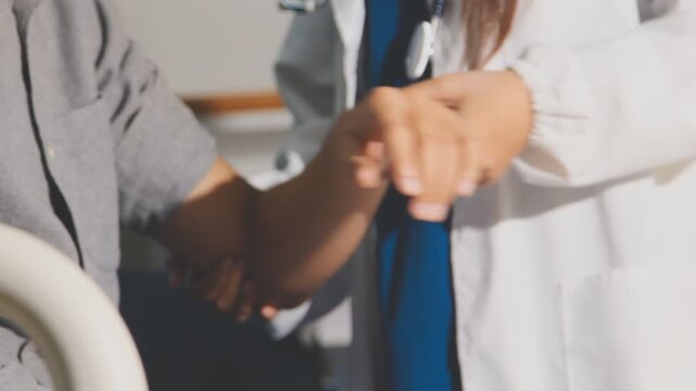 Physical therapist performs shoulder range of motion test on male patient