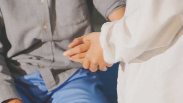 Physical therapist performs shoulder range of motion test on male patient