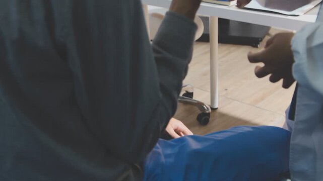 Physical therapist performs shoulder range of motion test on male patient