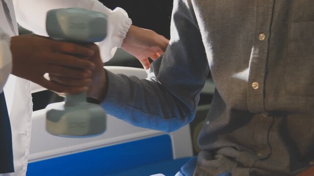 Physical therapist performs shoulder range of motion test on male patient
