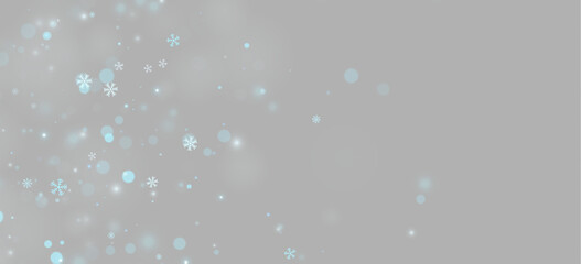 Frozen snowflake shapes drift across a dark background. Blue bokeh circles and soft glowing orbs create a layered and diffuse lighting effect. This image can enhance winter or. © longstock