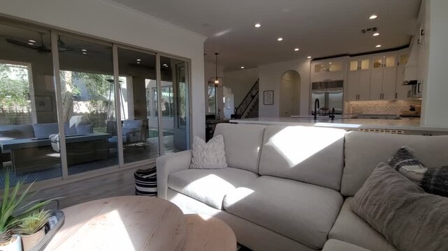 Bright modern living room with white sofa and open kitchen