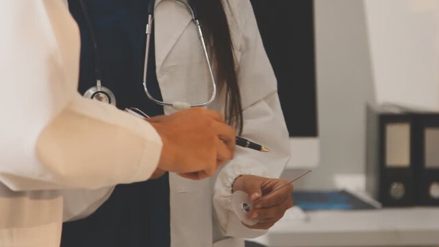 Doctor holding and pointing to an anatomical model of human lungs in a clinical office setting