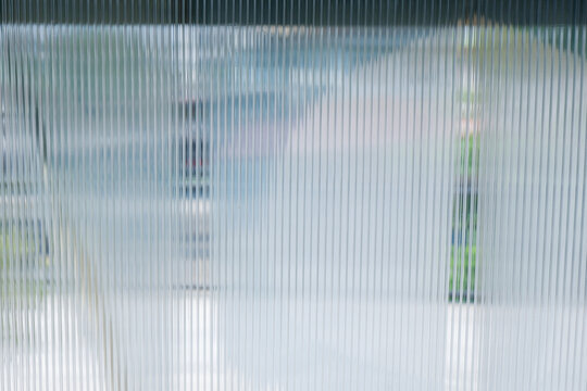 A Close up of corrugated glass texture with reflected,modern home decor,stylish home decor,Creative composition of living room,Wave glass vertical line pattern,Template,space for text.