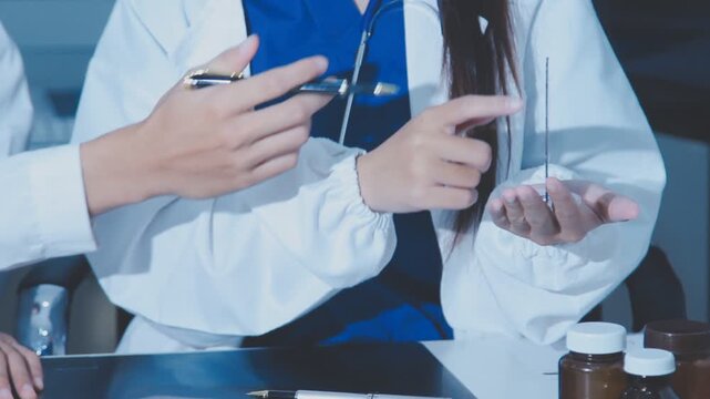 Doctor holding and pointing to an anatomical model of human lungs in a clinical office setting