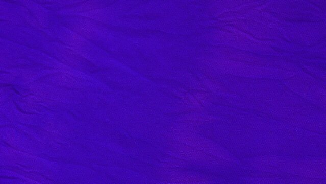 Wrinkled purple fabric texture with soft shadows for textile background