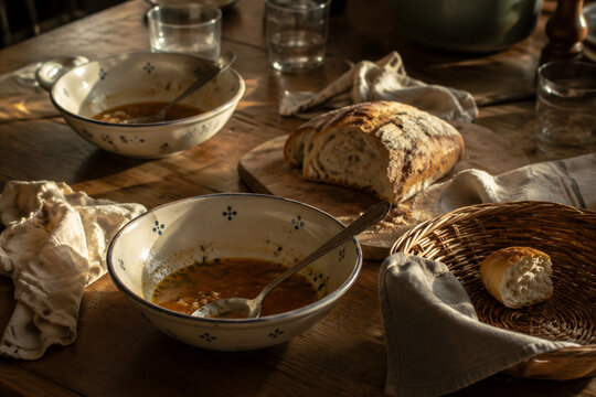 Dinner table with soup bowls and bread remnants, family meal and togetherness concept