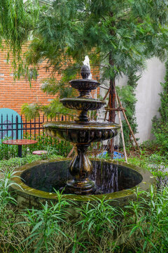 Luxury Fountain at green garden in house outdoor garden,Scenic View of a Beautiful English Style Landscape Garden in summer,selective focus.