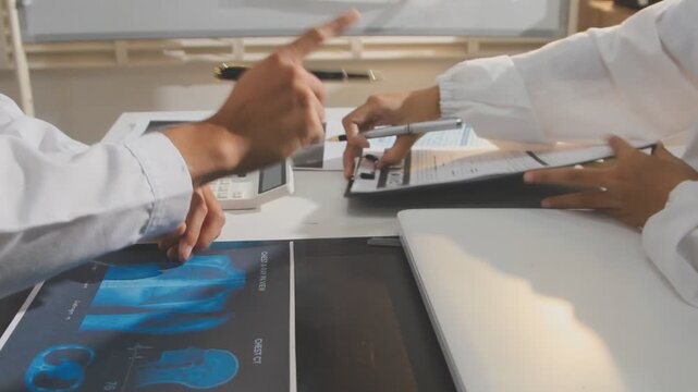 Doctor holding and pointing to an anatomical model of human lungs in a clinical office setting