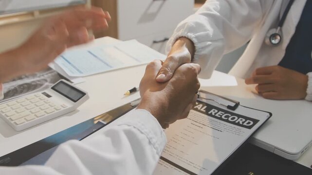 Doctor holding and pointing to an anatomical model of human lungs in a clinical office setting