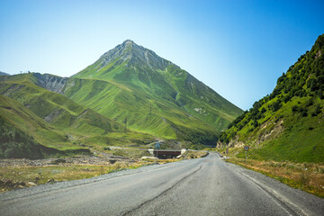 Naklejka premium Georgia mountain road Caucasus highlands scenic highway green peak travel, empty asphalt route through summer landscape, tourism, adventure, mobility and driving.