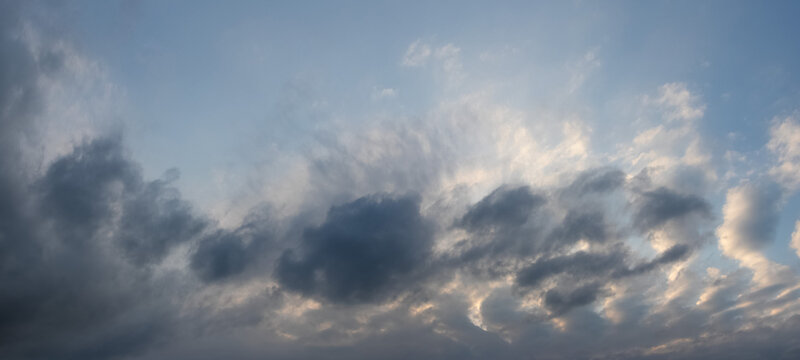 Picturesque clouds lit by sunlight in evening sky
