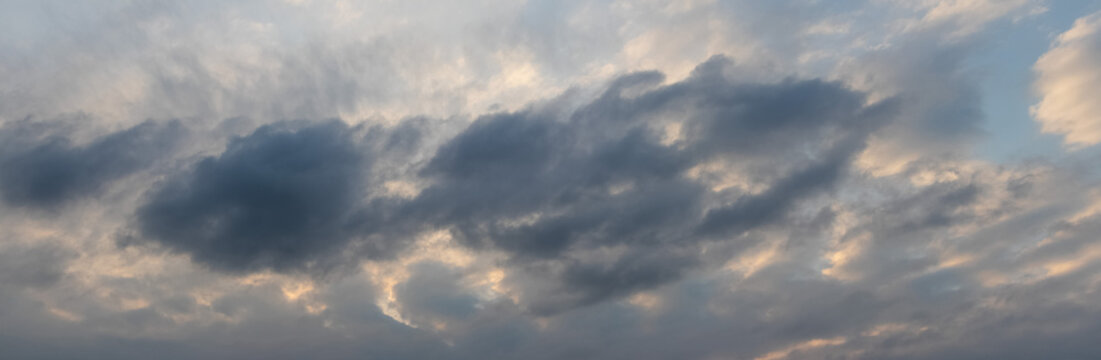 Dramatic dark clouds in evening sky before sunset