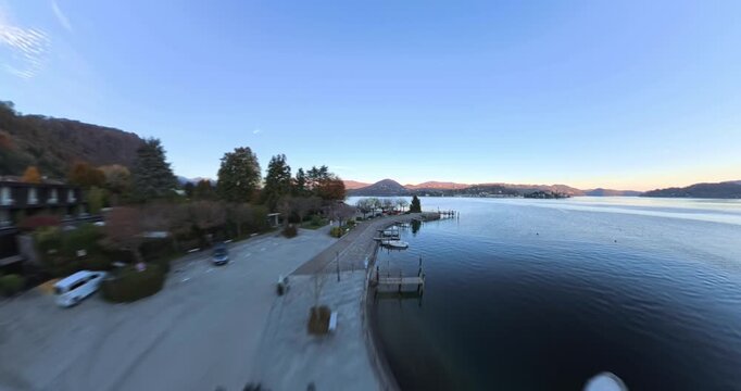 Waterfront promenade and boat dock in Pella along Lake Orta in Piedmont, Italy. Aerial drone