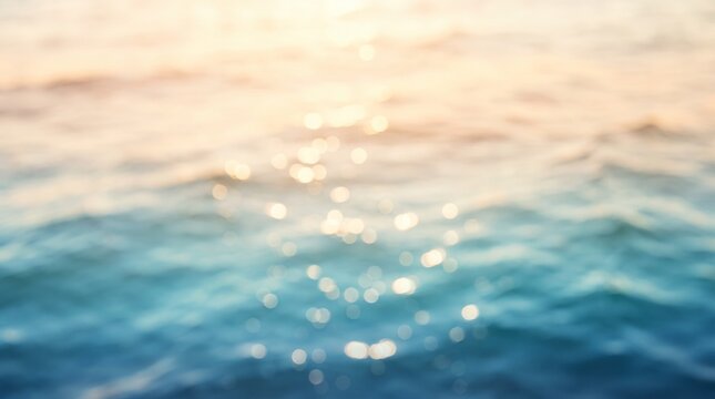 Blurred ocean waves reflect golden sunset light creating a peaceful abstract background texture.