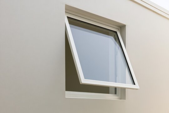 White aluminium framed awning window on a modern home facade
