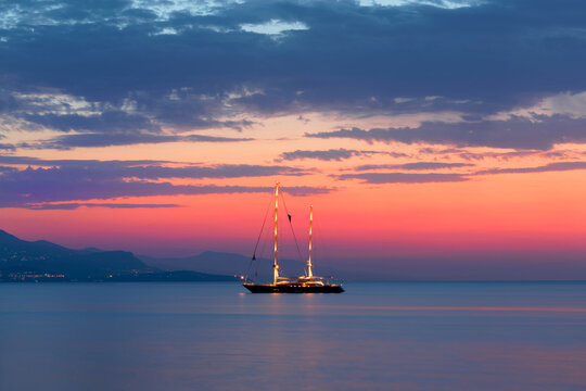 Sailing yacht at sunset, Antibes bay, French Riviera.