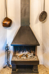 Naklejka premium Traditional Mediterranean fireplace with antique copper cookware