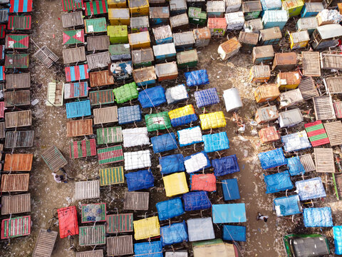 Aerial view of the Van Stand with a dense grid of colorful rickshaw vans parked in rows, showcasing vibrant patterns and textures in Narayanganj, Dhaka, Bangladesh.