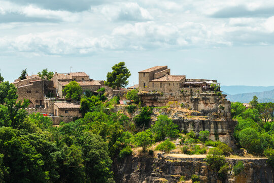 Stone buildings of Siurana village perched on rocky cliffs above forested valleys, iconic medieval settlement in Tarragona province Catalonia Spain