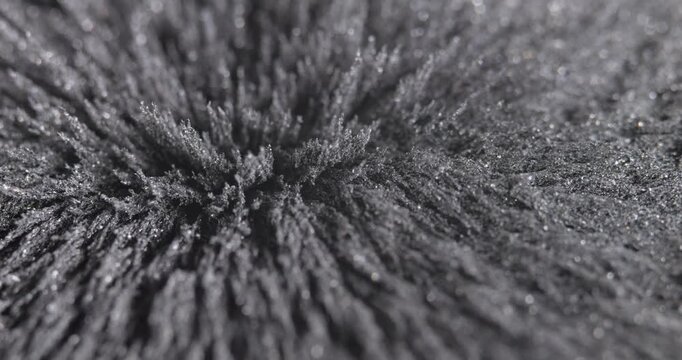 Metal dust, shavings, iron powder under the influence of a magnetic field. Abstract background.