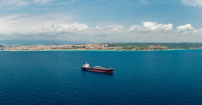 Cargo vessel anchored in Mediterranean Sea near Tarragona coastline Spain
