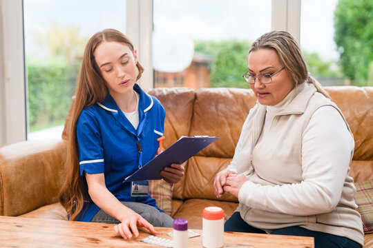 Health care worker talks to patient in a home setting about treatment options during a visit