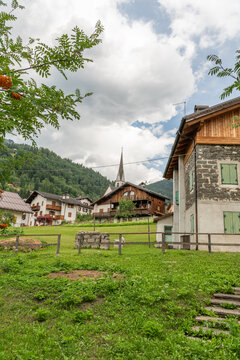 Alleghe, Italy. Traditional Alpine village with historic stone and wooden houses in the Dolomites