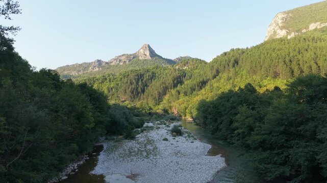 Drone Aerial View Flying Over Dried Neretva River Bed Revealing Exposed Gravel Sand and Mountain Peaks in Glavaticevo