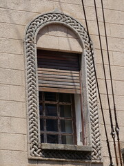 Fototapeta premium Neo-Byzantine stone arch window decoration on an old building