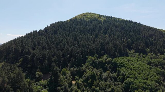 Drone Aerial View Flying Towards Bosnian Pyramid of the Sun Covered in Dense Green Forest in Visoko