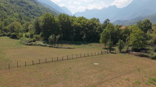 Drone Aerial View Flying Over Meadow Fence and Dry Stone Wall in Bijela Village Mountain Valley