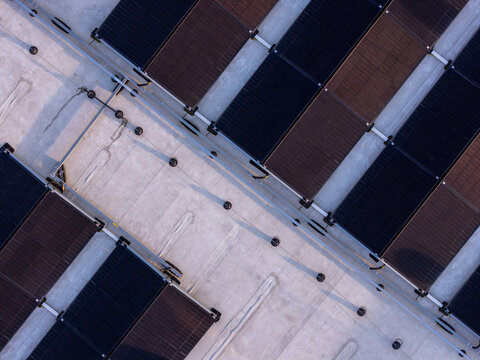 Aerial view of solar panels installed on a flat roof, showing the geometric arrangement of photovoltaic modules in Gdansk, Poland.