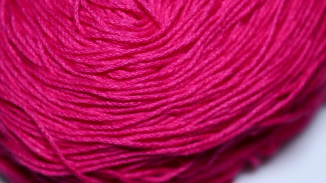 A close-up shot of a ball of yarn. Rotating in a circle