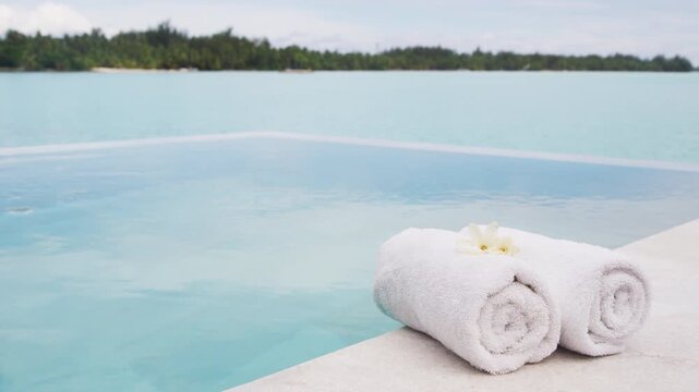 Spa wellness Luxury vacation with towel by infinity pool hotel resort.