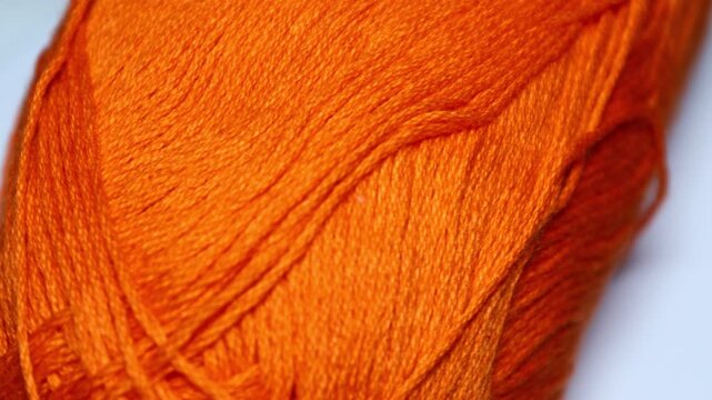 A close up shot of a ball of yarn, perfect for craft or textile related projects. Rotating in a circle