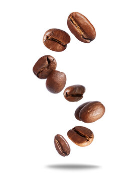 Falling roasted coffee beans in the air close-up on a transparent background