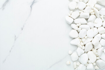 White pebble stones on marble background, top view © Liami