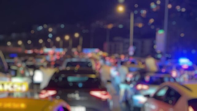 A blurry video showing a major traffic jam on Altinyol Street in Izmir after a midnight accident, with flashing police lights and drivers standing outside their vehicles in frustration.