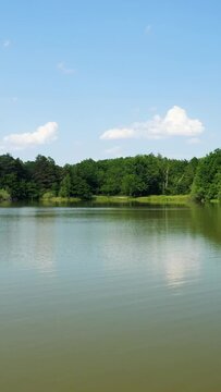 A vertical 9:16 video captures the tranquil waters of Etang du Gue l'Eveque in Dampierre-en-Burly, Loiret, Centre-Val de Loire, France.