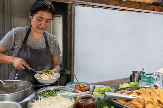 Street food vendor preparing regional meal
