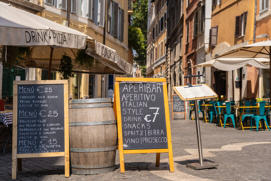 Restaurant and aperitivo signs on a street in Rome, Italy