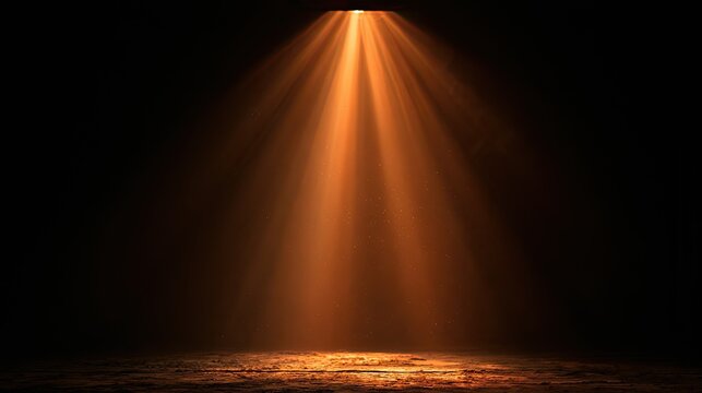 A single, powerful beam of warm orange light illuminates a textured, dark ground
