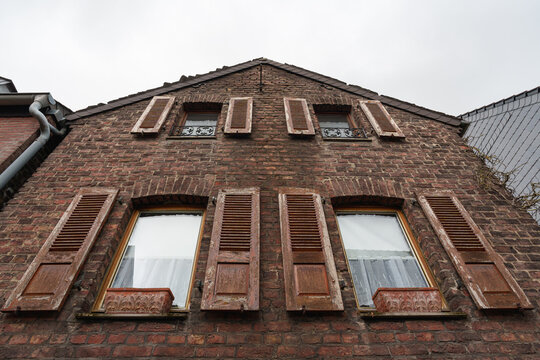 Weathered shutters and brickwork highlight the traditional architecture of Zons, Germany