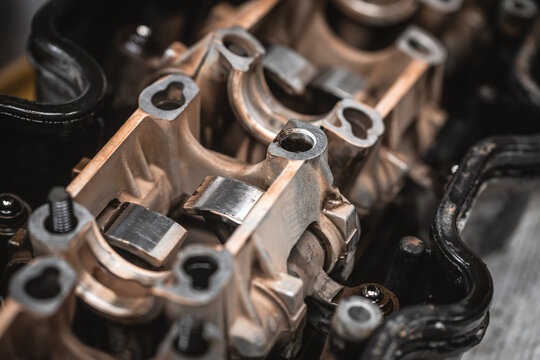 Close-up view of intricate engine valve train components and metal parts