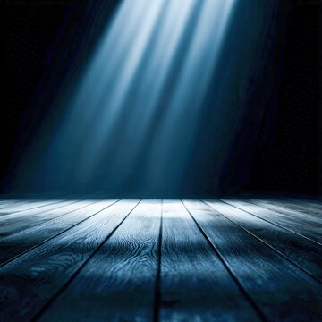 Light beams illuminate a wooden stage in a dim room