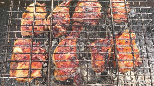 Grilling chicken on an outdoor barbecue in the backyard