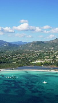 Vertical 9:16 aerial video of Spiaggia Lu Impostu beach in San Teodoro, Sardinia, Italy.